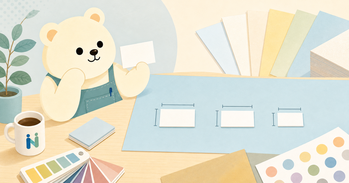 クマのキャラクターが複数の名刺サイズを比較しているイラスト